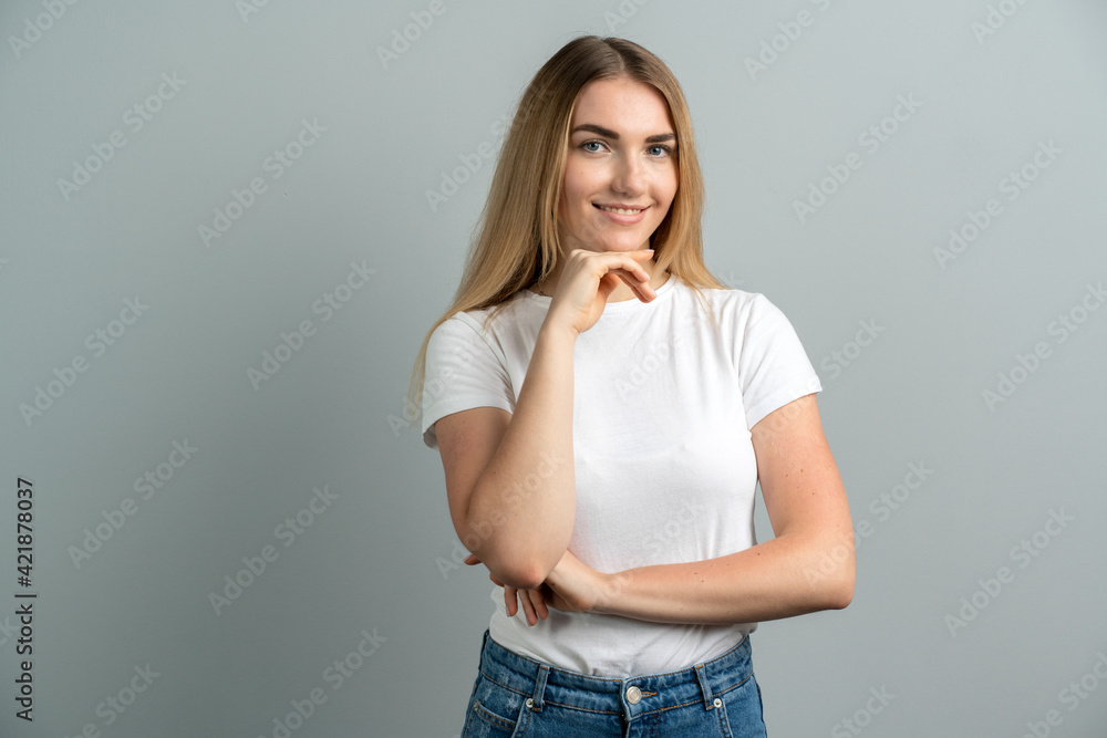 Pretty female with blonde hair, dressed casually, looking at the camera, being happy. Shot studio of a beautiful woman, isolated from a blank studio wall. Pretty female with blonde hair, dressed casually, looking at the camera, being happy. Shot studio of a beautiful woman, isolated from a blank studio wall.