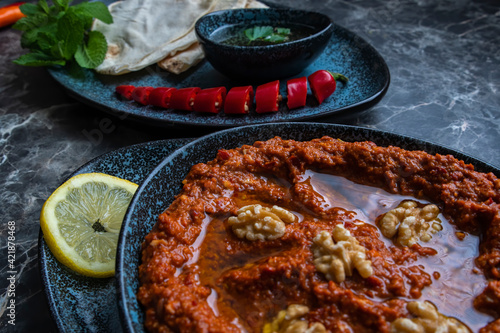 Mhammara is a hot pepper dip originally from Aleppo, Syria , Lebanon found in Levantine and Turkish cuisines. photo