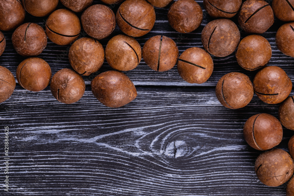 Fototapeta premium Macadamia nuts are cracked and baked to taste extremely delicious. Toasted organic healthy food.