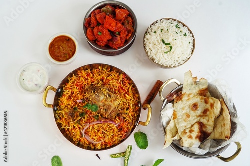 Indian Non veg meal Chicken biryani Roti Chilli chicken rice salan and Raita isolated on white