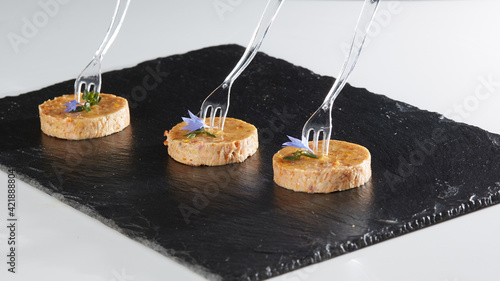 Yummy tuna canape on black stone. Shallow dod photo