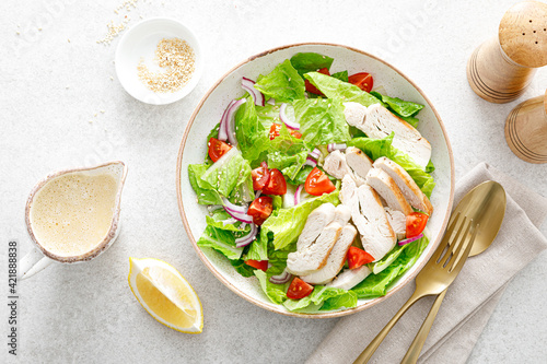 Salad with romaine lettuce, grilled chicken meat and tomatoes