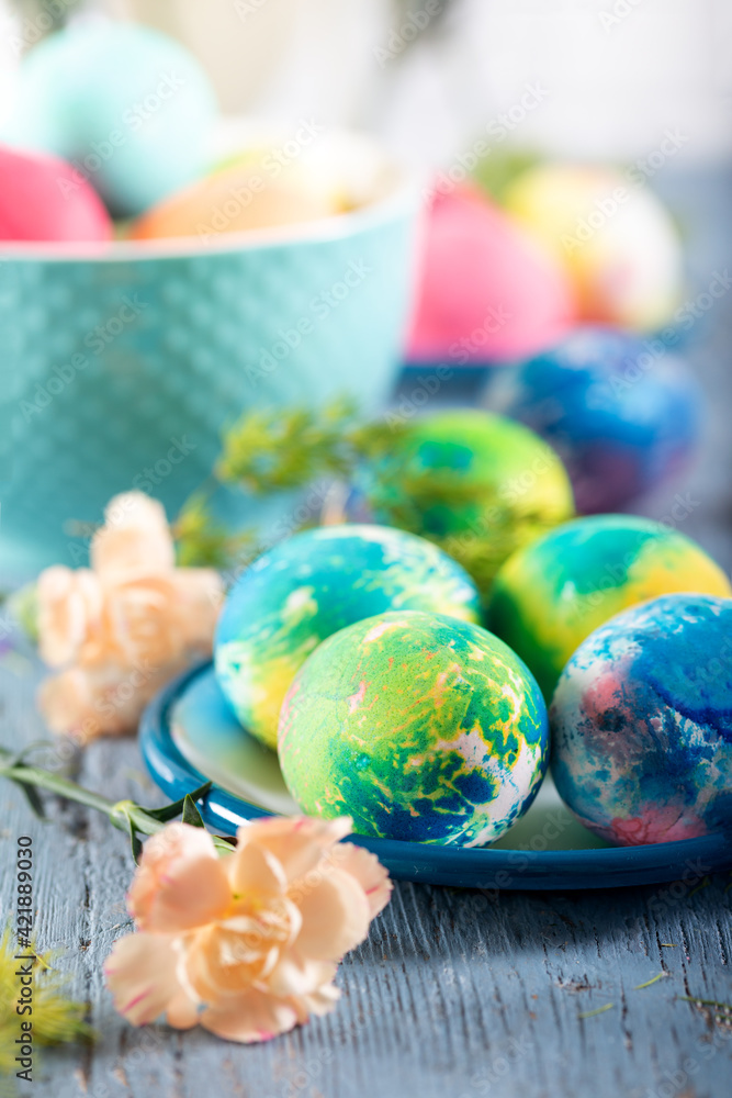 Colorful easter eggs on a blue wooden table. Selective focus. Colorful easter eggs on a blue wooden table. Selective focus.