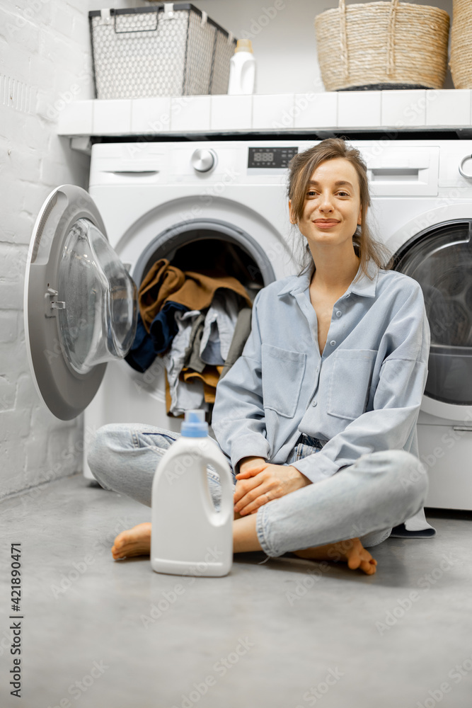 Woman in the laundry room at home Woman in the laundry room at home