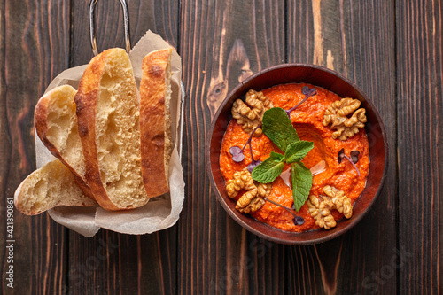 Muhammara, Eastern snack on a dark wooden board photo