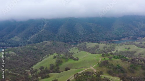 Clouds drift across peaceful green hills and valleys in the tri-valley area in Northern California. This beautiful region is known for its productive vineyards and farms. photo