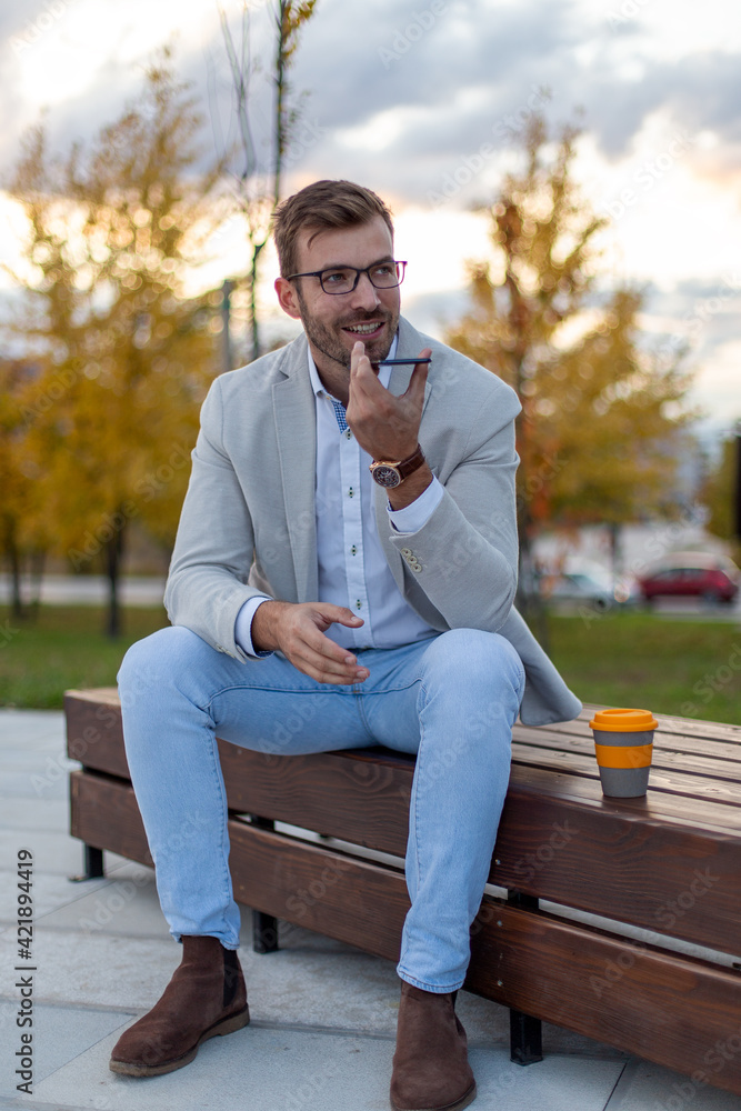 Obraz premium Portrait of a young businessman talking on the phone. 