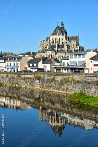 River in the town of Mayenne with Notre-Dame basilica , commune in the Mayenne department in north-western France