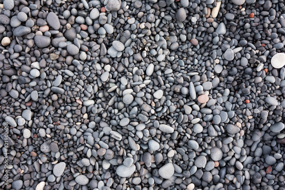 Gray pebbles as a background in the Iceland sea shore. Abstract composition. Design image. Gray pebbles as a background in the Iceland sea shore. Abstract composition. Design image.