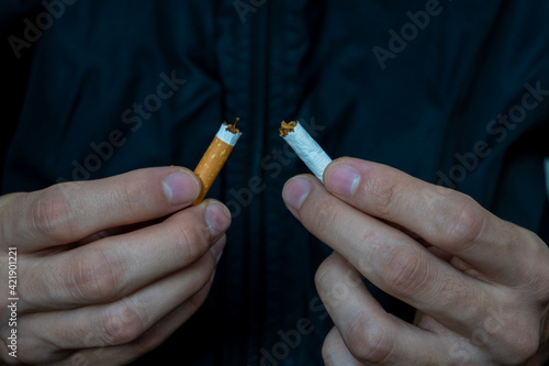 Young man breake down cigarette. Winning with addicted nicotine problems, stop smoking . Quitting from addiction concept.