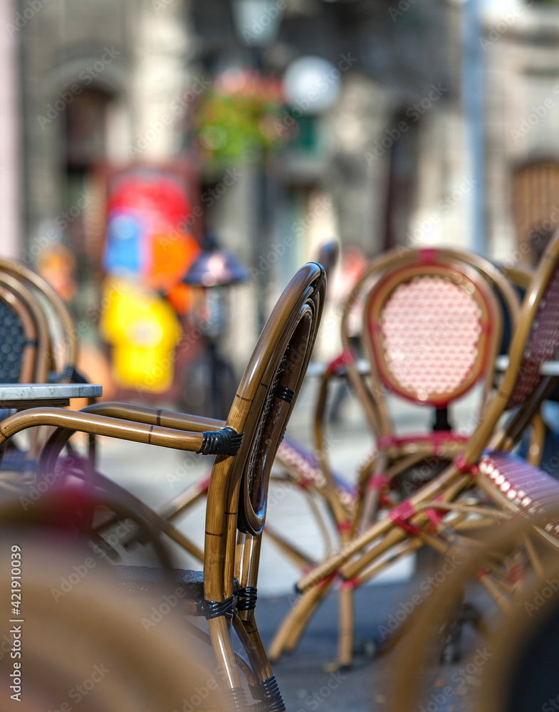 An empty summer outdoor area of a restaurant or cafe in a historic downtown is closed during lockdown. Tables and chairs without visitors. Challenging times business in HoReCa during a pandemic. An empty summer outdoor area of a restaurant or cafe in a historic downtown is closed during lockdown. Tables and chairs without visitors. Challenging times business in HoReCa during a pandemic.