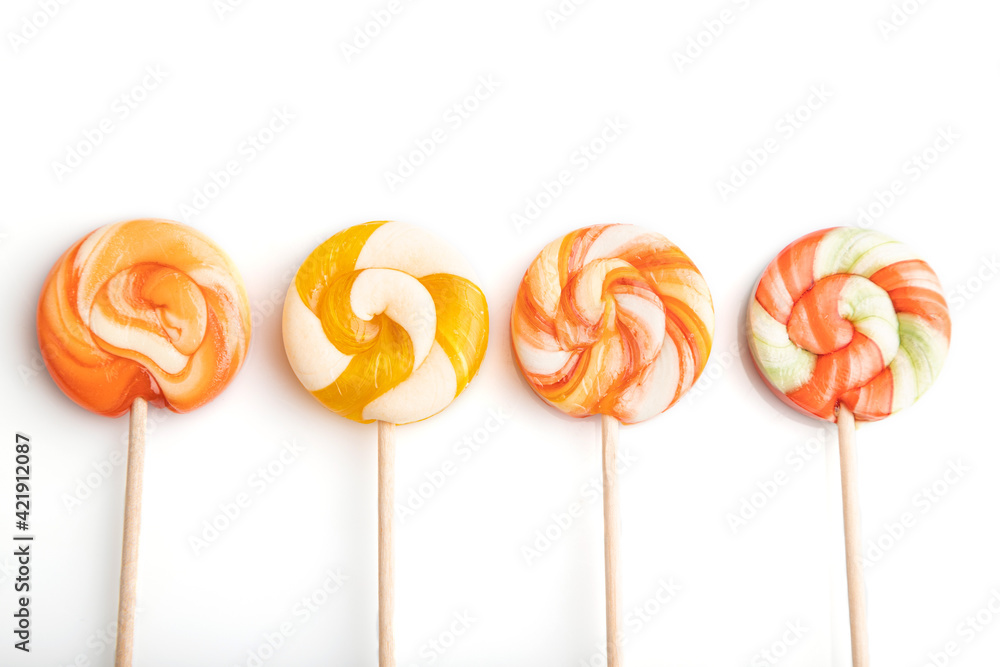 Four lollipop candies isolated on white background. close up, top view. Four lollipop candies isolated on white background. close up, top view.