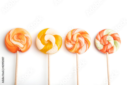Four lollipop candies isolated on white background. close up, top view.