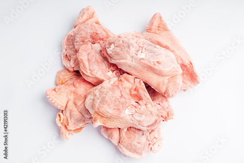 Raw chicken meat. Chicken offal, bones, backs on a white background. Chicken bones for soup. Product for retail.chicken meat sliced as food background