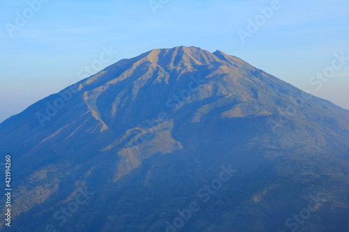 Merbabu Mountain on a sunny morning seen from Boyolali, Central Java, Indonesia.