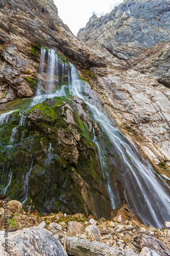 Man on Gega waterfall. The most famous and largest waterfall in Abkhazia. Georgia. Gega waterfall in mountains of Abkhazia. Gagra Range. View to Gega waterfall. Abkhazia photo