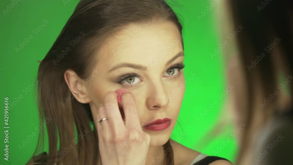 a young european woman does her makeup before a date a young european woman does her makeup before a date