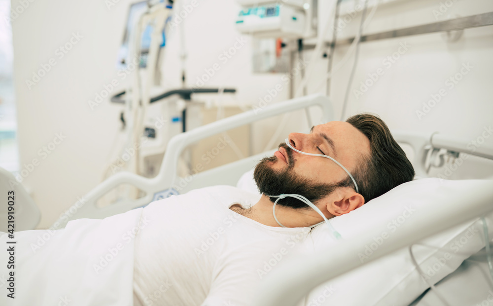 Infected patient with coronavirus in quarantine ward is lying in bed in the hospital. Infected patient with coronavirus in quarantine ward is lying in bed in the hospital.