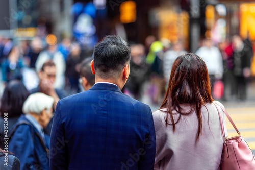 Chinese man and woman walking in Hong Kong, East Asia