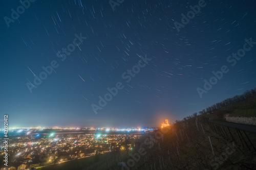 Star trails over a vineyard and the Rhine valley at Schriesheim in Germany.