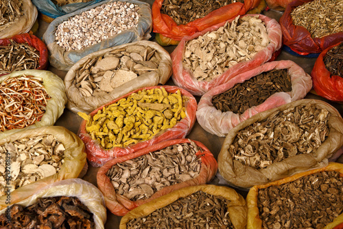 Fotografie Bags of dried spices for sale in open-air market, Ganlanba (Menghan), Xishuangba