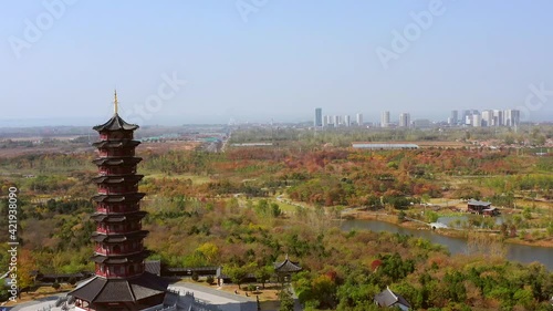 Aerial photo of the tower in Santai Mountain Park in Suqian, Jiangsu Province, and bird's-eye view of the Chinese antique wooden tower in autumn park photo