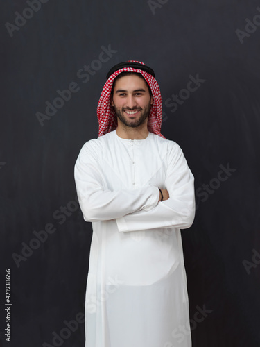 Portrait of young muslim man wearing traditional clothes photo