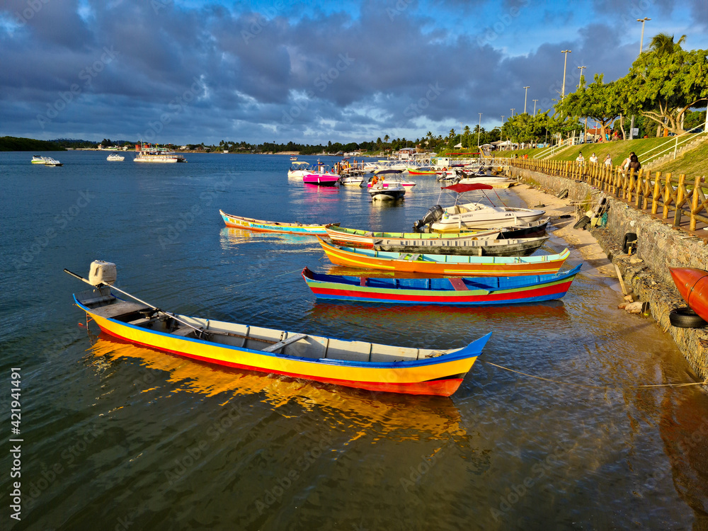Barcos a remo coloridos ancorados na beira de um rio
