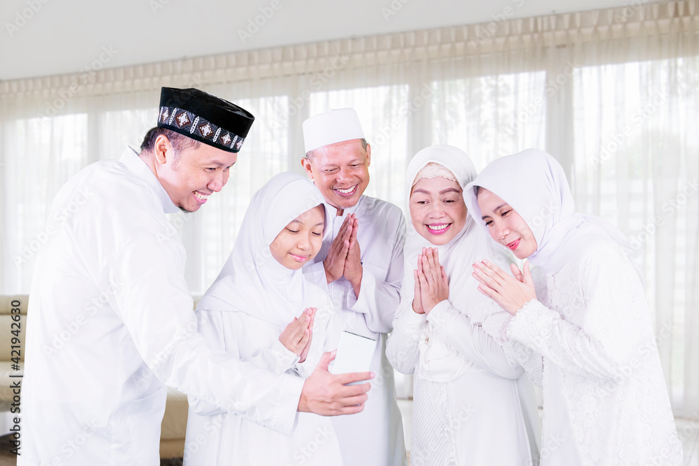 Family show congratulate gesture Eid on cellphone