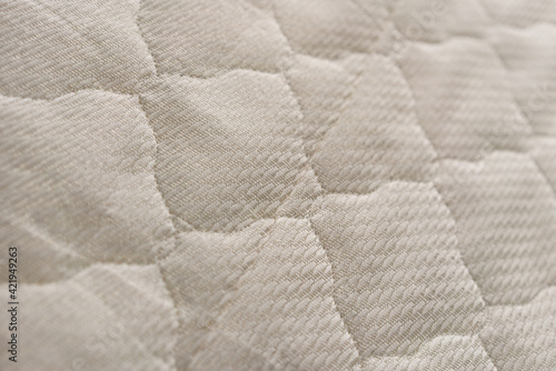 Background of the upholstery of the mattress closeup.