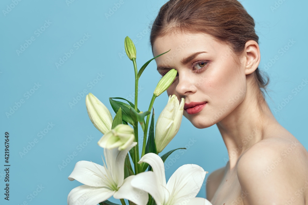 charming woman with white flowers on blue background portrait cropped view charming woman with white flowers on blue background portrait cropped view