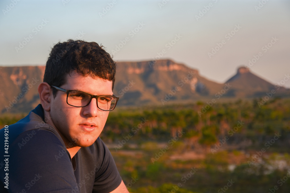 man sitting with mountain landscape in the background man sitting with mountain landscape in the background