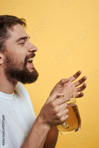 bearded man in white t-shirt beer fun alcohol yellow background