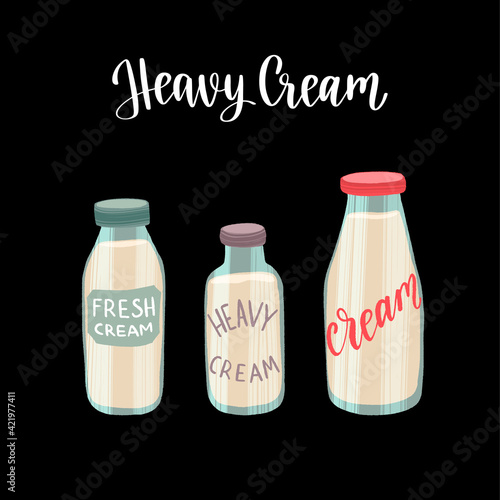 Fresh and tasty heavy cream in the different glass bottles. Healthy nutrition product.