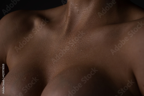 Augmentation breast surgery. Closeup naked girl chest.