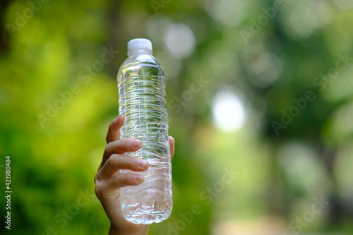 bottle of water in green natural background and space