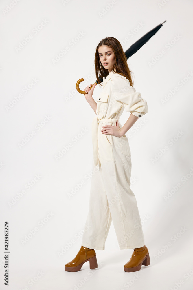 Woman in white suit umbrella in hands fashionable clothes modern style isolated background Woman in white suit umbrella in hands fashionable clothes modern style isolated background