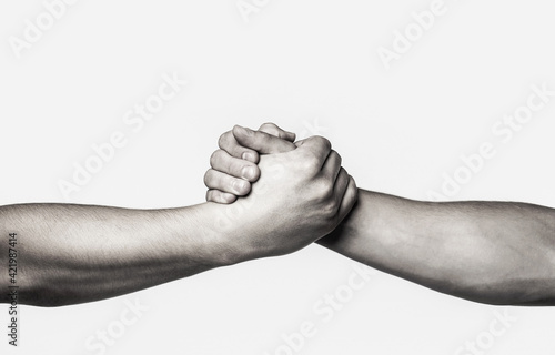 Rescue, helping gesture or hands. Two hands, helping arm of a friend, teamwork. Helping hand outstretched, isolated arm, salvation. Black and white photo