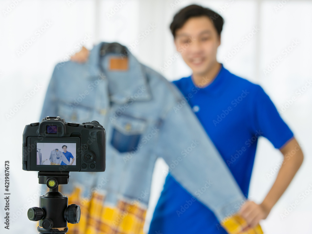 Asian man showing trendy shirt for blog audience