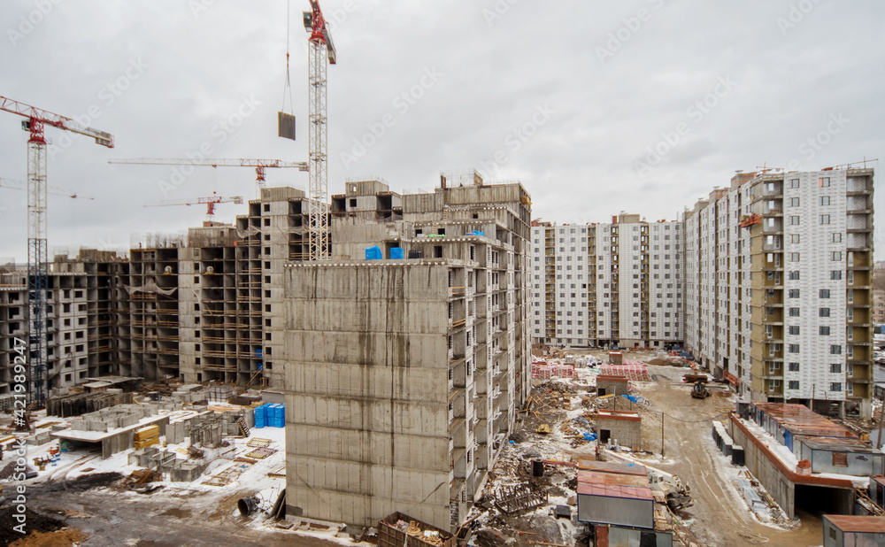 New construction of an unfinished multi-storey residential building. multi-storey residential building with cranes. New construction of an unfinished multi-storey residential building. multi-storey residential building with cranes.