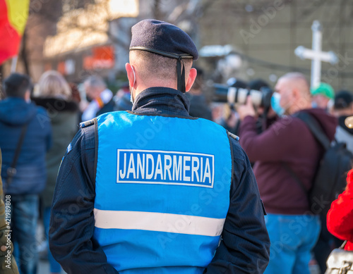 Police officers and Gendarmerie or military police closely supervising the demonstrators from University square at the protest against anti covid vaccine and coronavirus restrictions.