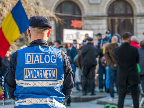 Police officers and Gendarmerie or military police closely supervising the demonstrators from University square at the protest against anti covid vaccine and coronavirus restrictions.