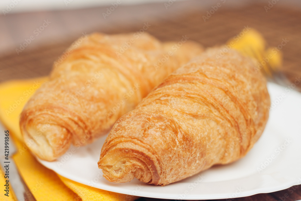 croissants saucer on the table fork with a knife fresh pastries dessert morning croissants saucer on the table fork with a knife fresh pastries dessert morning