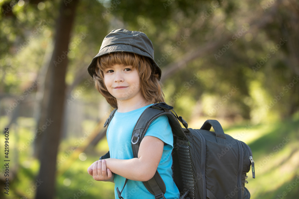 little boy with backpack hiking in scenic mountains. Boy local tourist goes on a local hike little boy with backpack hiking in scenic mountains. Boy local tourist goes on a local hike