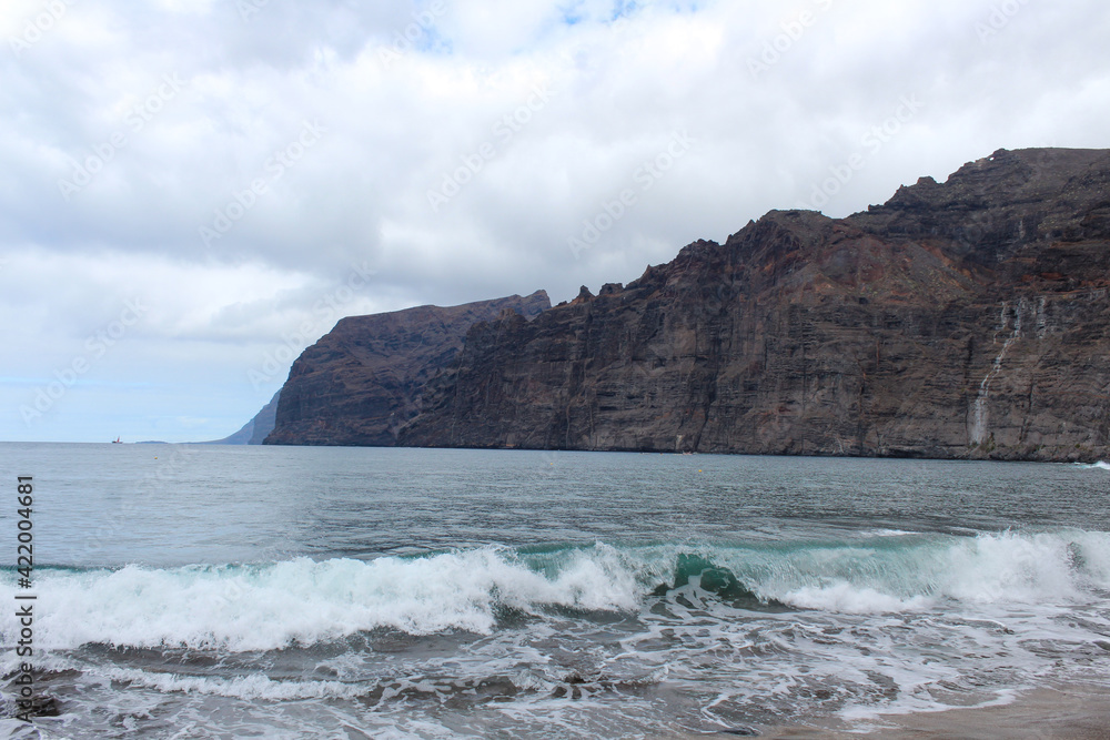 rocky coast of Tenerife with black sand on the beach