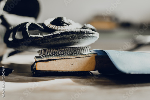 Wooden shoebrush next to ballroom dancing shoes. Use a brush to loosen the sole of the dance shoe to increase the stability of the wood floor. photo