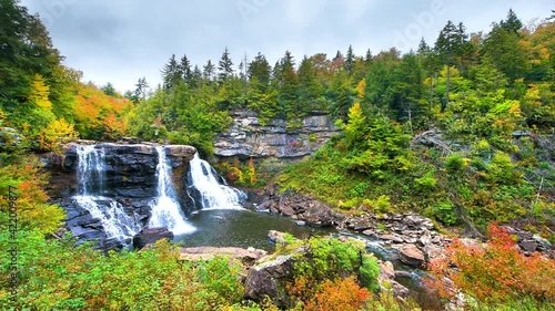 Point of view pov panning walking handheld shot of Blackwater Falls waterfall in state park, West Virginia at colorful autumn fall season with water flowing photo