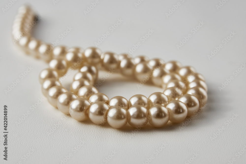 Pearl necklace on white background, close-up Pearl necklace on white background, close-up