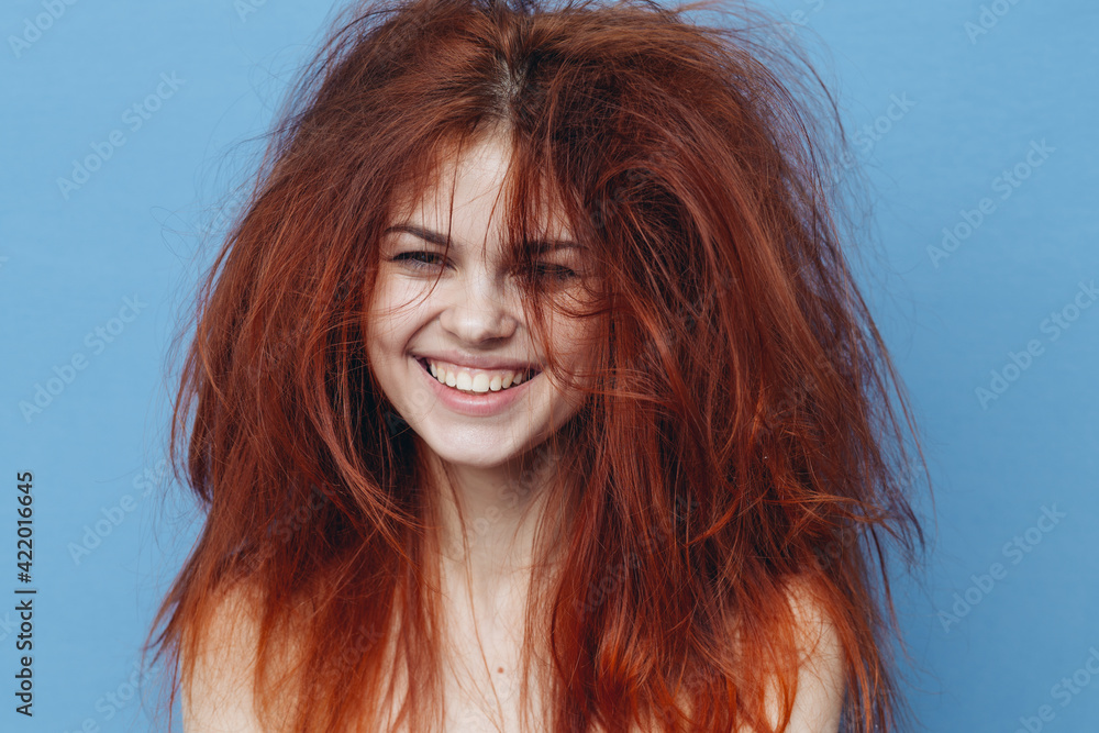 red-haired woman with tangled hair on her head on blue background cropped view red-haired woman with tangled hair on her head on blue background cropped view
