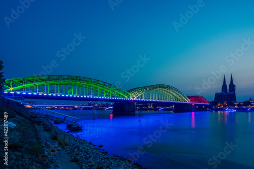 Panoramic view of Cologne Cathedral with Hohenzollern Bridge at the blue hour, Germany.